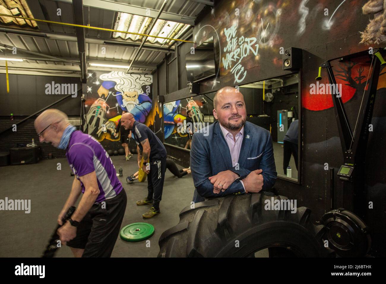 Businessman Chris Walsh Reform UK candidate and local gym owner with costumers at Trident Fitness, Morley, West Yorkshire, England. Stock Photo