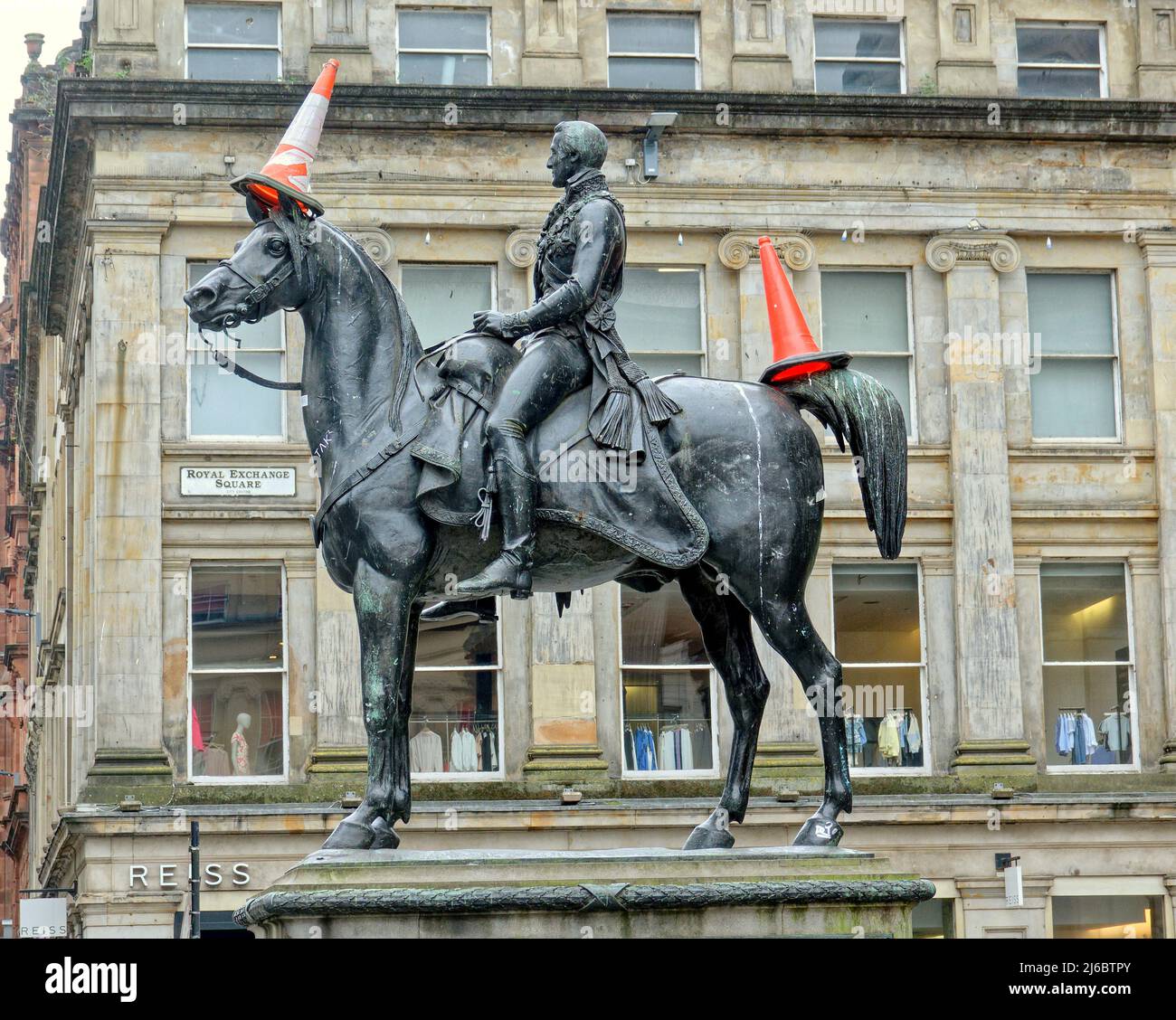 Glasgow, Scotland, UK 30th April, 2022. Controversial slave statues in the city suffered as the iconic cone head man has his headgear removed and placed on his horses rump while a normally unadorned assessor sir john moore statue  in george square had his face hidden in the strange cone war in the city. The dukes blushes were rectified by passing teenager. Credit Gerard Ferry/Alamy Live News Stock Photo