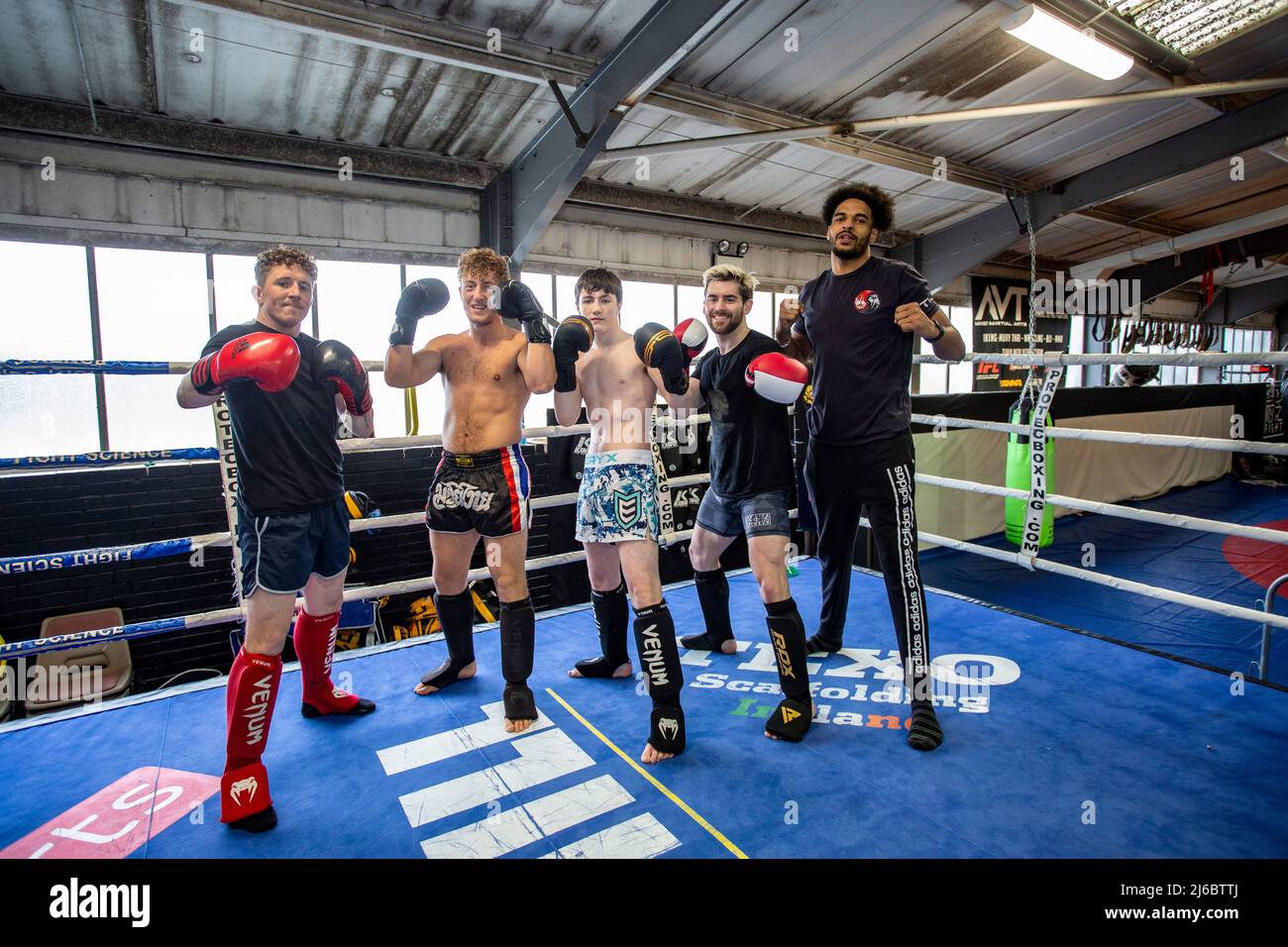 A group of young male Thai Boxing students posing at boxing rig at local gym in West Yorkshire, England. Stock Photo