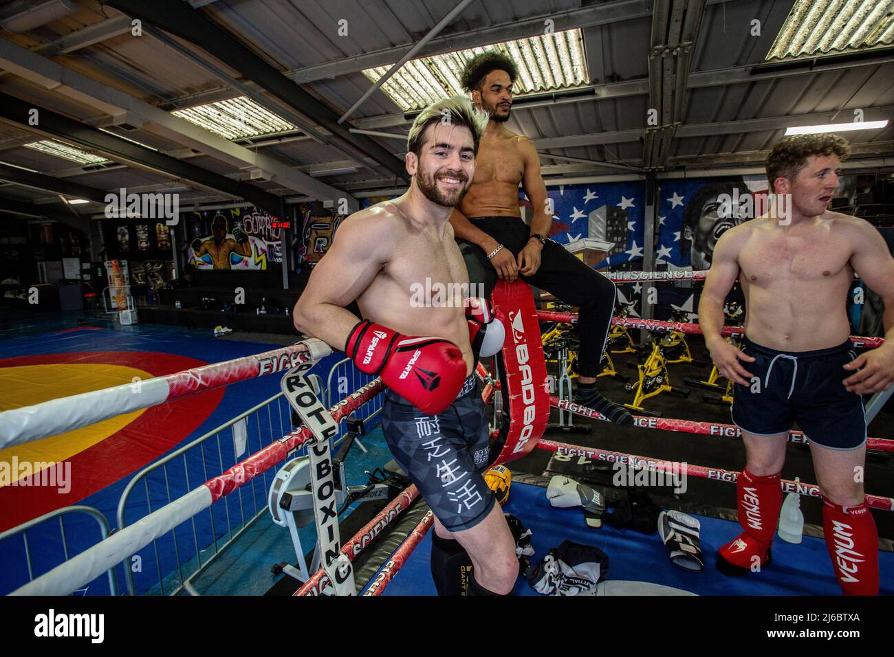 A group of young male Thai Boxing students posing at boxing rig at local gym in West Yorkshire, England. Stock Photo