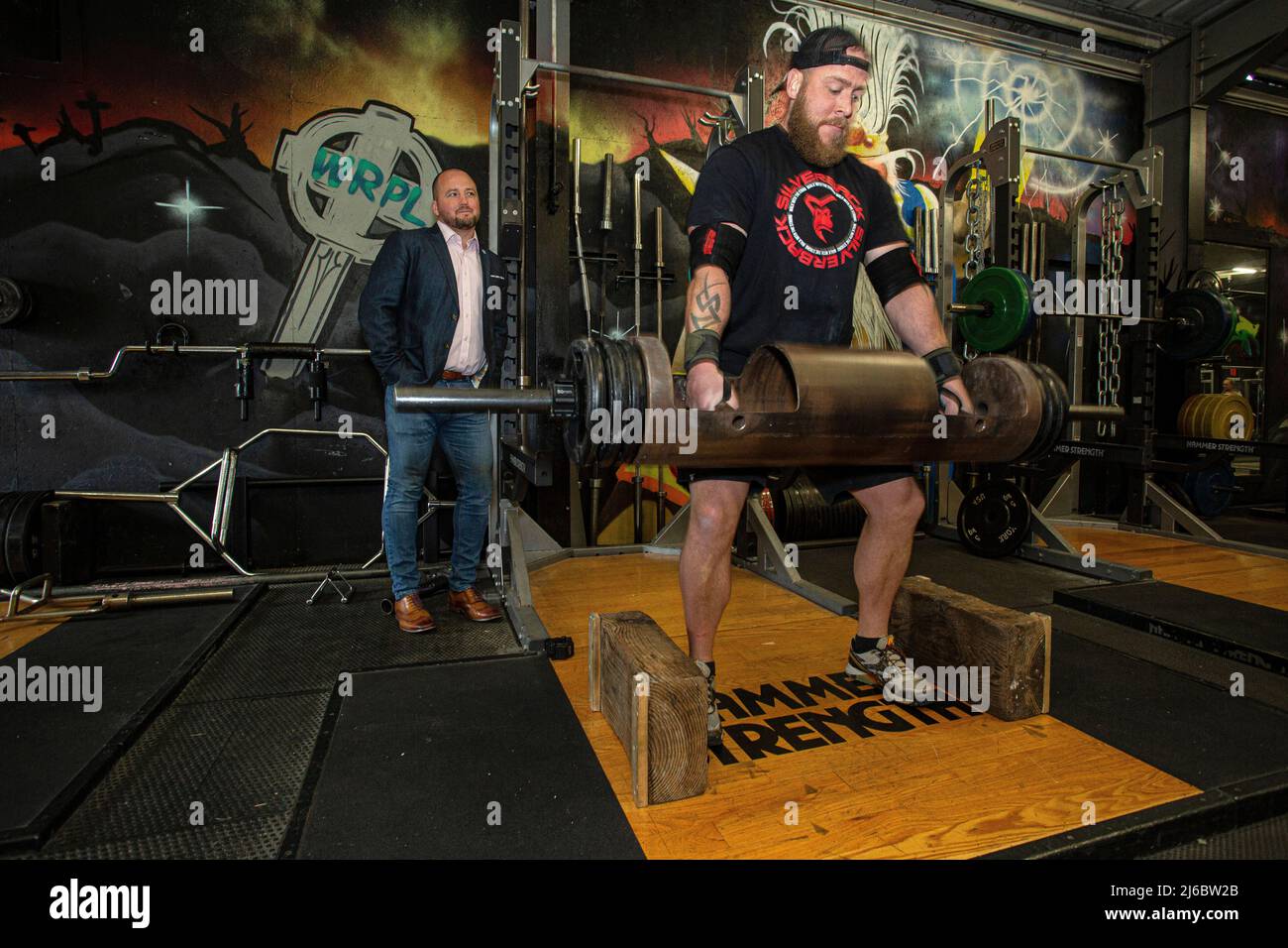 Businessman Chris Walsh Reform UK candidate and local gym owner with costumer James at Trident Fitness, Morley, West Yorkshire, England.© Horst Friedr Stock Photo