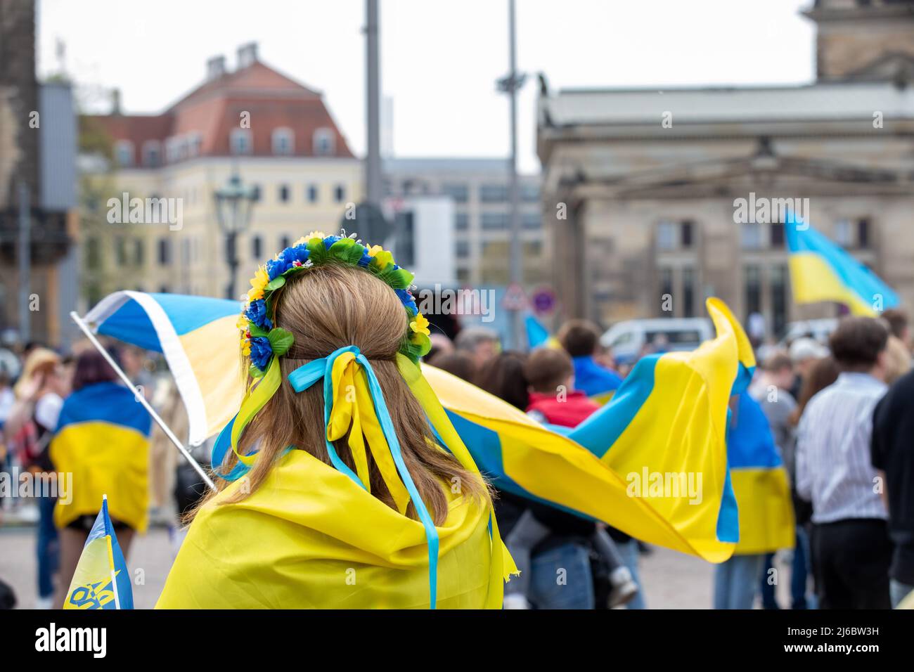 30 April 2022, Saxony, Dresden: A woman presents the Ukrainian flag in the air. The counter-event against pro-Russian rally entitled: 'Solidarity with the people of Ukraine! All together against Putin's war of aggression!' has several hundred participants. Photo: Daniel Schäfer/dpa Stock Photo
