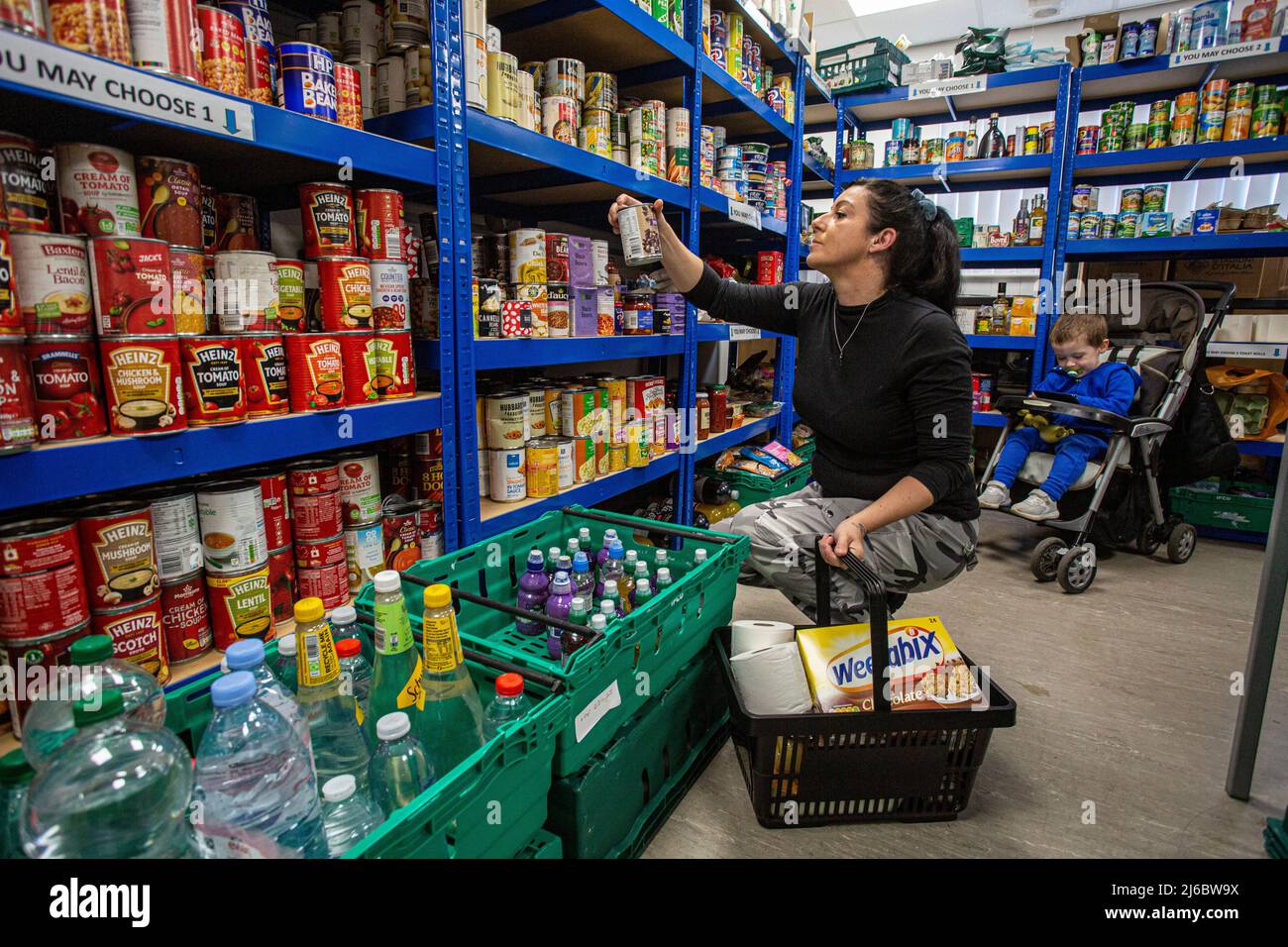 Mother with her son  at a food bank  at a community centre in England . Stock Photo