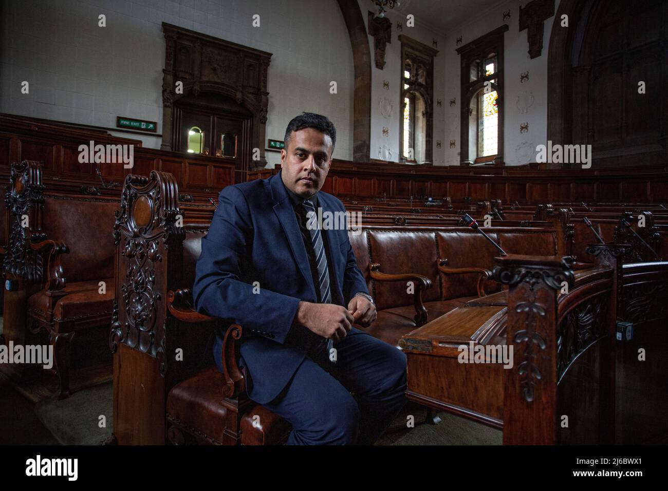 Conservative councillor Nadeem Ahmed sitting at historic Wakefield council hall , West Yorkshire, England. Stock Photo