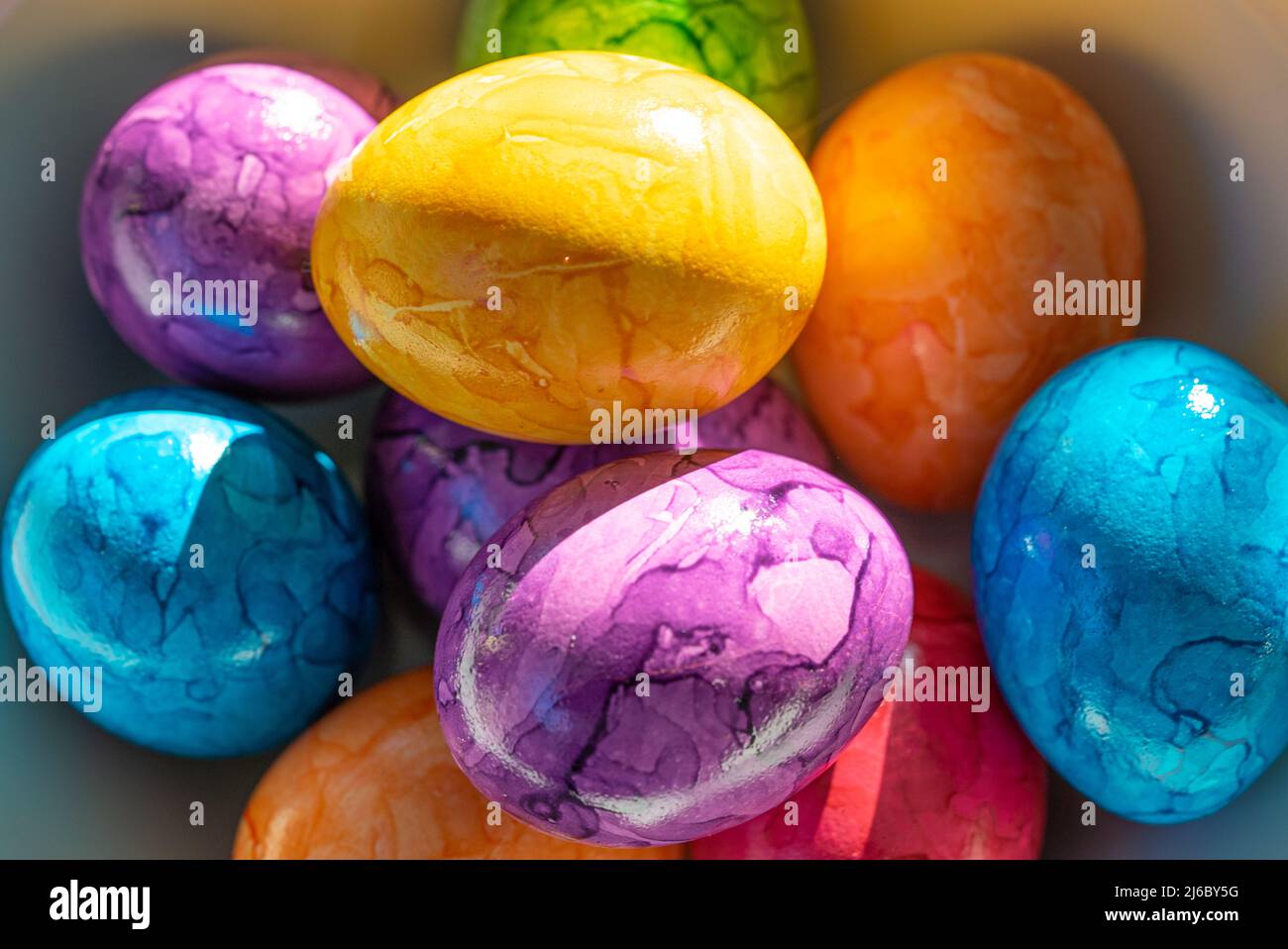 Brightly colored Easer eggs in a bowl Stock Photo