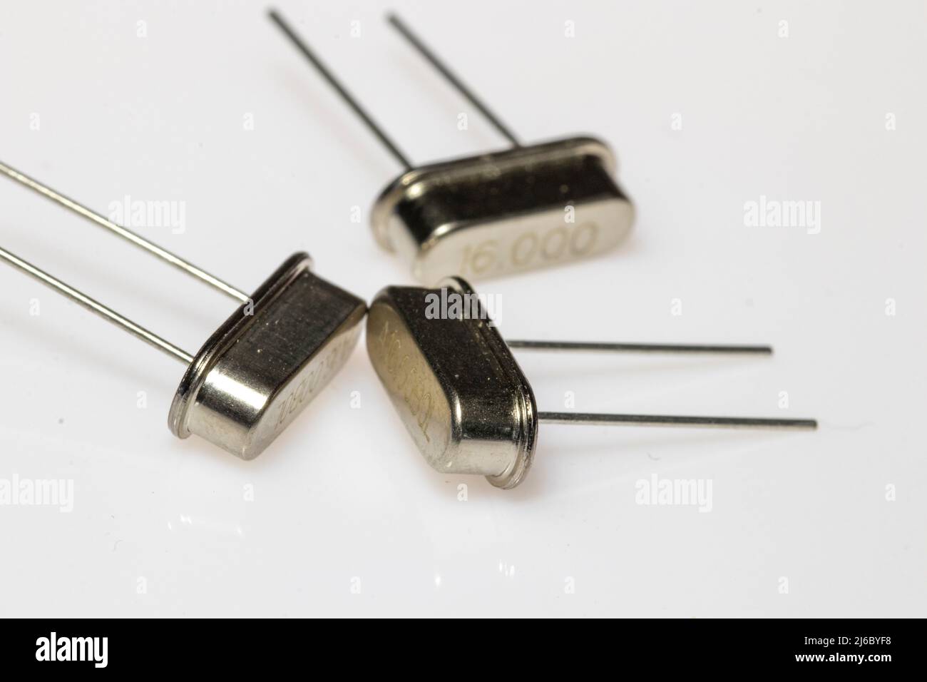 Crystal resonator in metal body on white background. Electronic