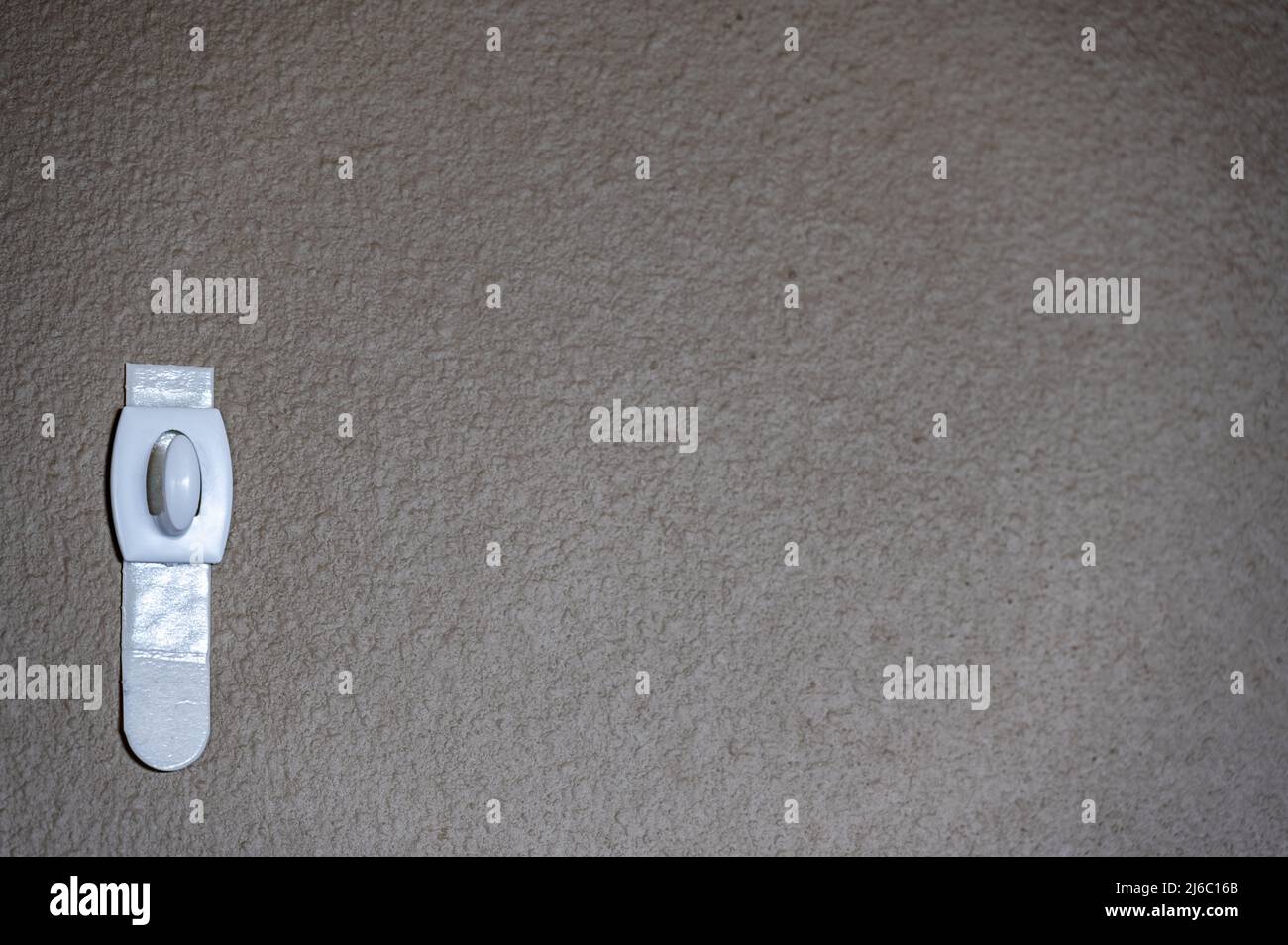 Selective focus on adhesive strip wall hanger that can be removed by