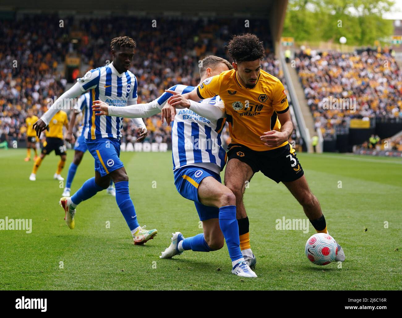 Brighton and Hove Albion's Solly March and Wolverhampton Wanderers' Rayan Ait-Nouri battle for the ball during the Premier League match at Molineux Stadium, Wolverhampton. Picture date: Saturday April 30, 2022. Stock Photo