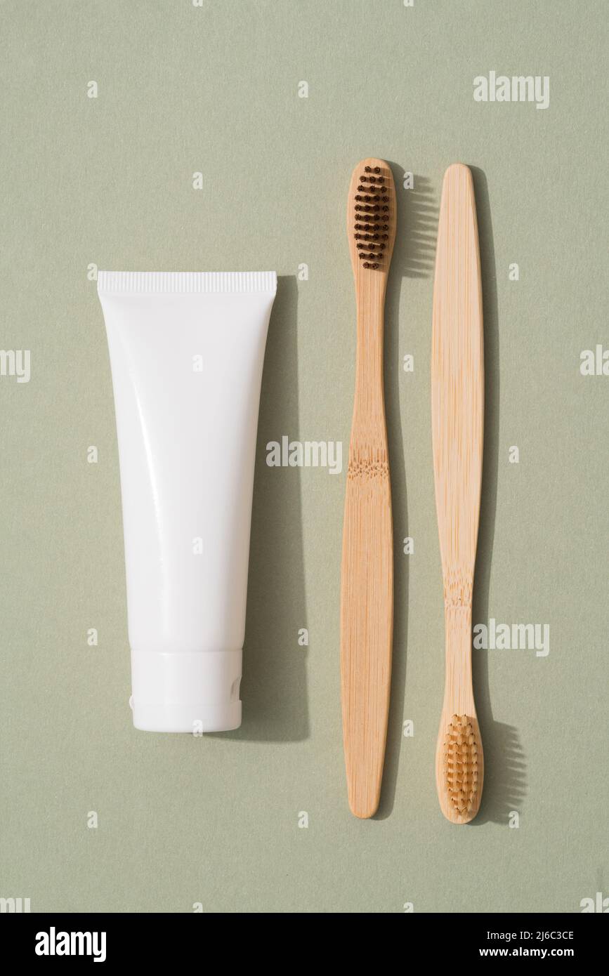 Vertical image of wooden bamboo toothbrush and tube with organic ...