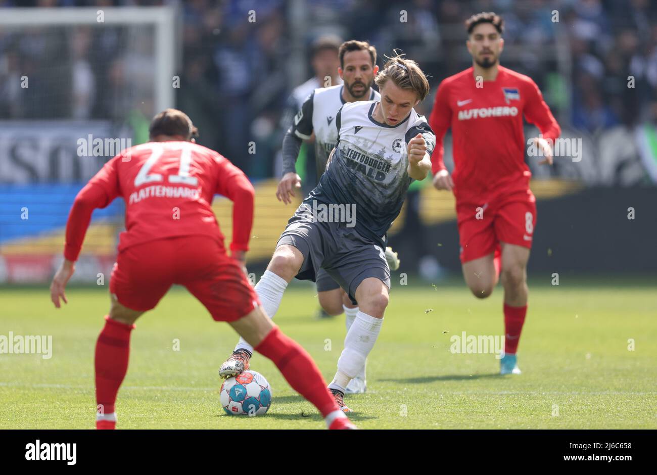 Germany. 30th Apr, 2022. 30 April 2022, North Rhine-Westphalia, Bielefeld: Soccer: Bundesliga, Arminia Bielefeld - Hertha BSC, Matchday 32 at Schüco Arena. Bielefeld's Patrick Wimmer (center) battles for the ball with Berlin's Marvin Plattenhardt (left). Photo: Friso Gentsch/dpa - IMPORTANT NOTE: In accordance with the requirements of the DFL Deutsche Fußball Liga and the DFB Deutscher Fußball-Bund, it is prohibited to use or have used photographs taken in the stadium and/or of the match in the form of sequence pictures and/or video-like photo series. Credit: dpa picture alliance/Alamy Live Ne Stock Photo