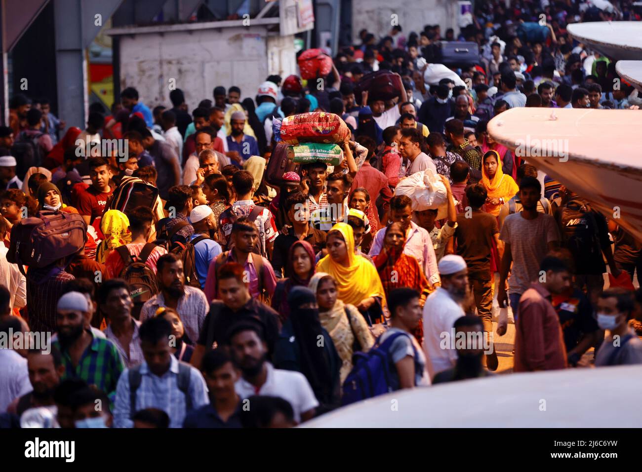 People gather to get onboard passenger ferries to travel home to celebrate Eid al-Fitr, at the Sadarghat Launch Terminal, in Dhaka, Bangladesh, April 30, 2022. REUTERS/Mohammad Ponir Hossain Stock Photo