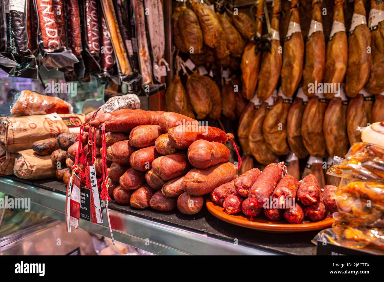 Serrano and iberian iberico ham legs, sausage, and chorizo on display