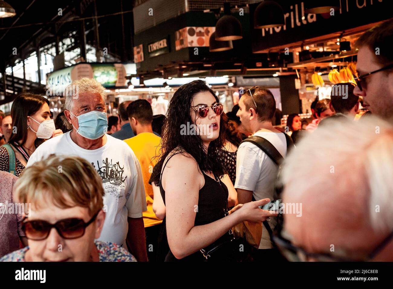 Barcelona, Spain. April 30, 2022.  Tourists and visitors crowd La Boqueria Market in Barcelona. After two years of pandemic and with the end of all restrictions, mass tourism is back to the Mediterranean city of Barcelona, opposition forces in the Barcelona City Council are asking for measures to alleviate the effect of tourist overcrowding on some neighborhoods of the city. Credit:  Jordi Boixareu/Alamy Live News Stock Photo