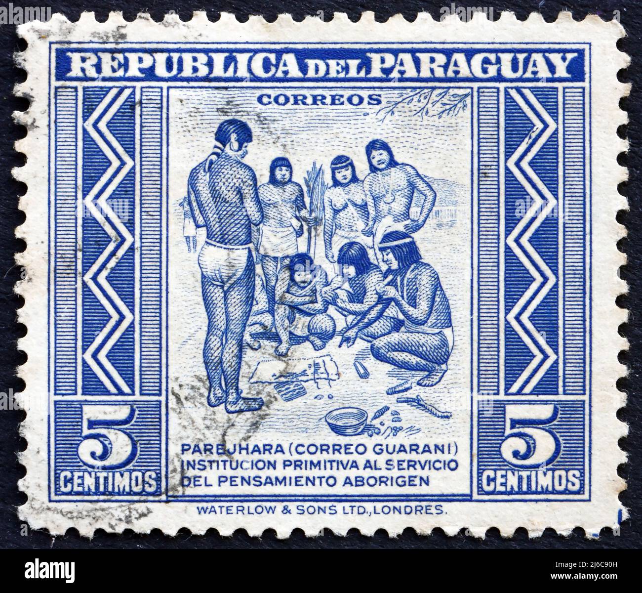 PARAGUAY - CIRCA 1946: a stamp printed in Paraguay shows Primitive Postal Service among Indians, circa 1946 Stock Photo