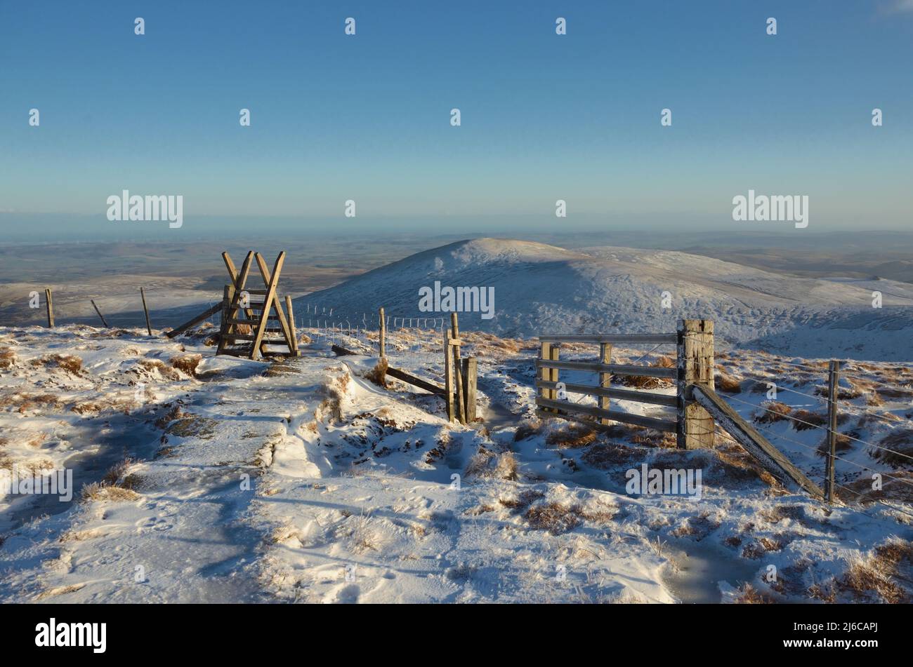 A stile in the snow on the top of Cheviot hill in Northumberland National Park, England Stock Photo