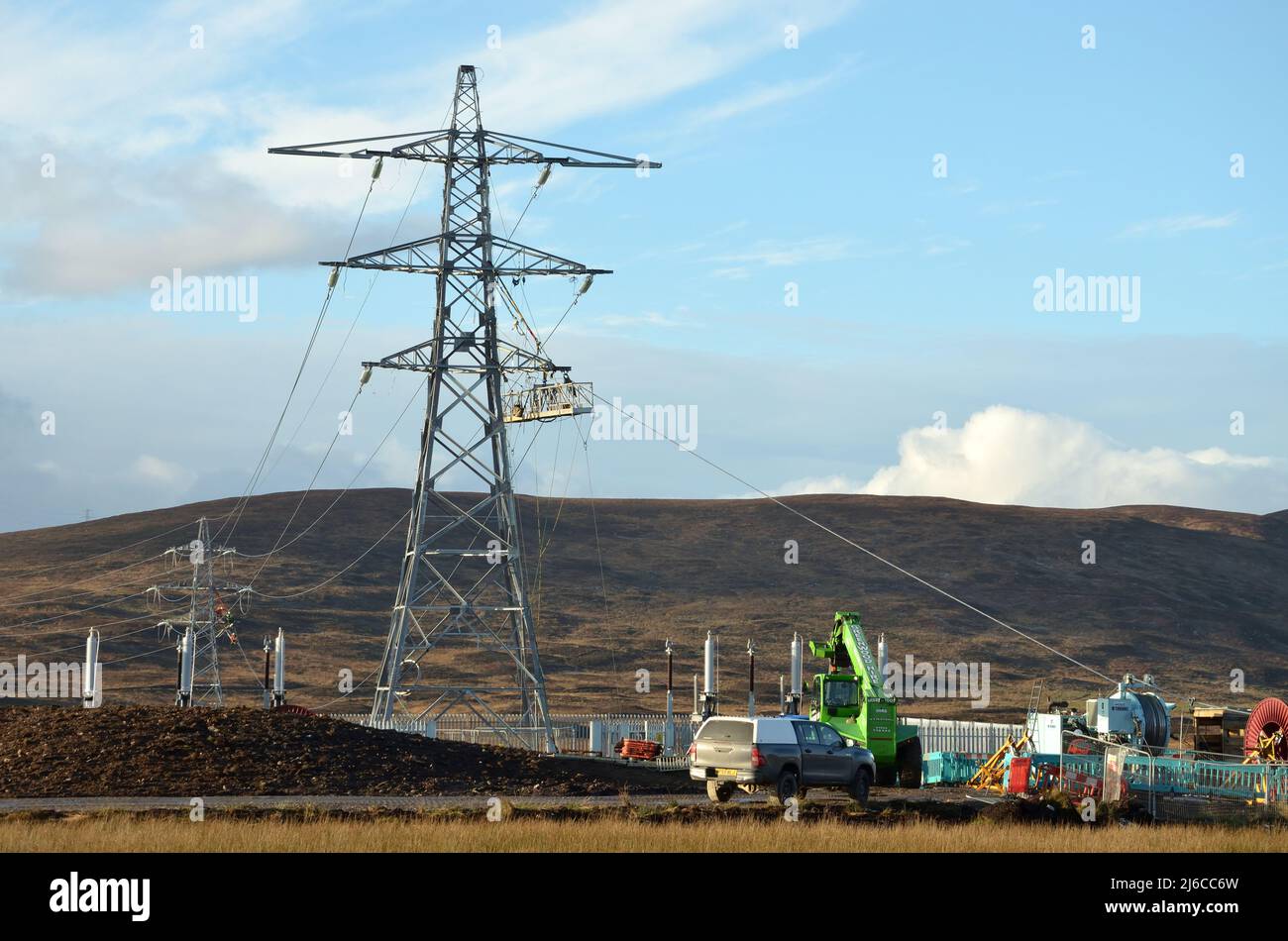 Overhead power line construction work at Loch Buidhe near Lairg in the Scottish Highlands to allow for more renewable energy generation. Stock Photo
