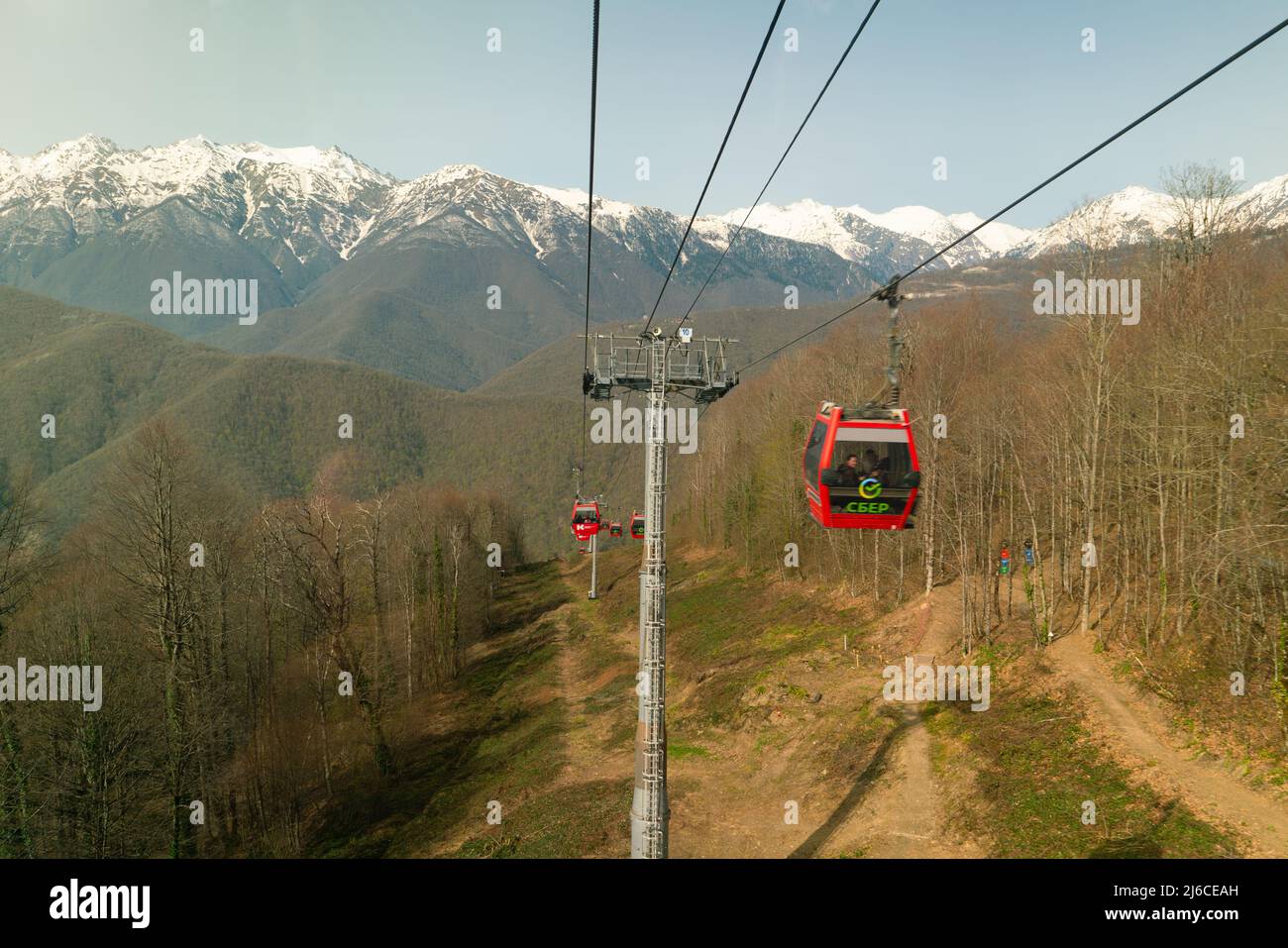 Sochi, Russia - April 23, 2022: Scenic mountain landscape with cable car of Krasnaya Polyana resort. Cable lift cabins with a view of the Caucasus Mou Stock Photo