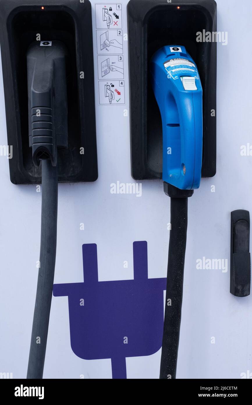 Close-up of CHAdeMO and CCS (Combo Charging System) type connectors and instructions for use in an electric vehicle fast charging station in Spain Stock Photo