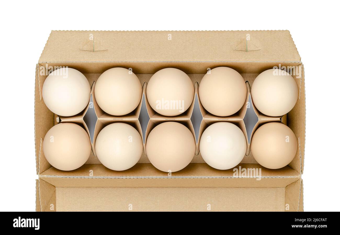 Fresh chicken eggs in a cardboard container, from above. Raw, organic and brownish hen eggs, in a recycled paper egg box. Common food. Stock Photo