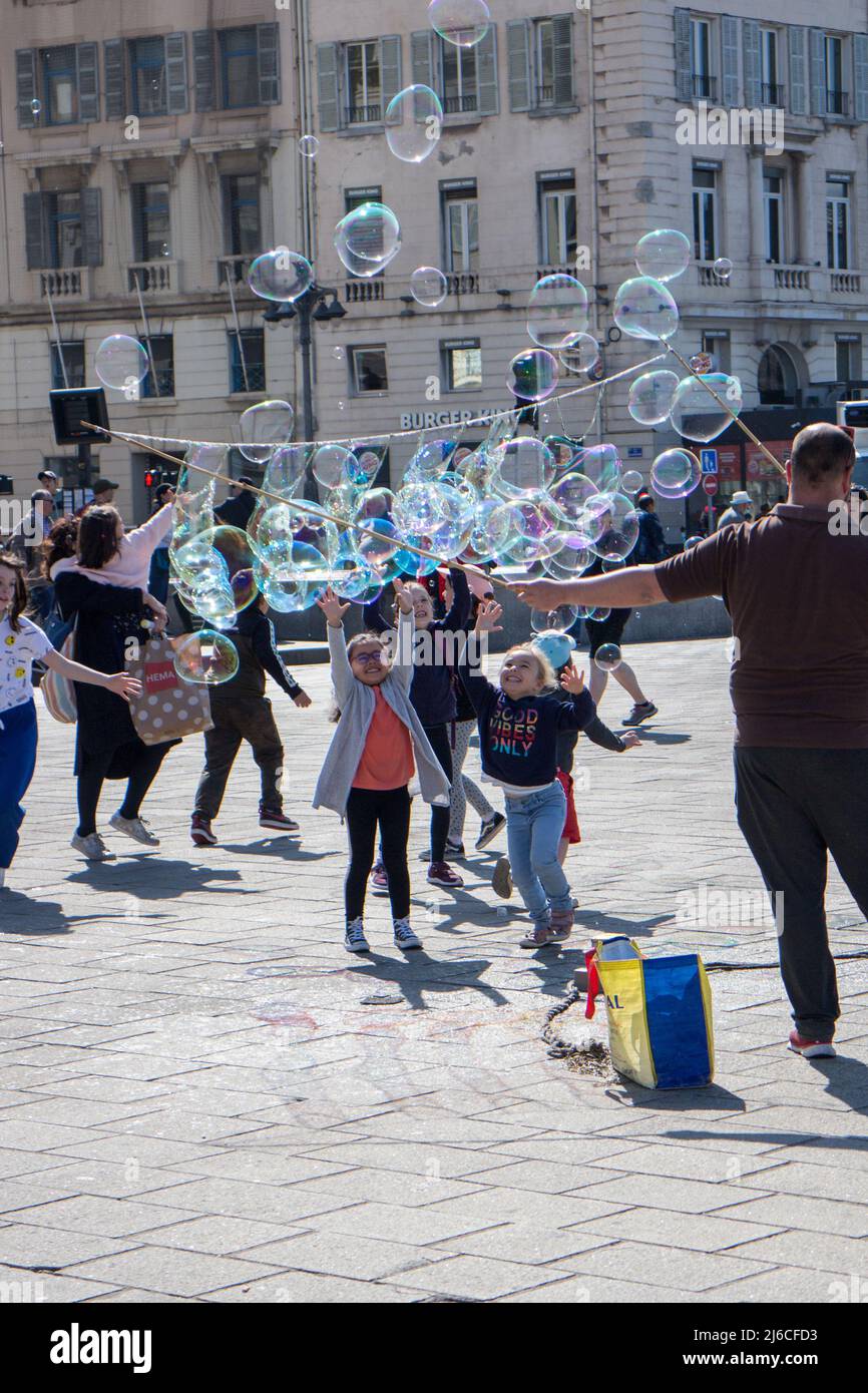 Children playing with soap bubbles Stock Photo
