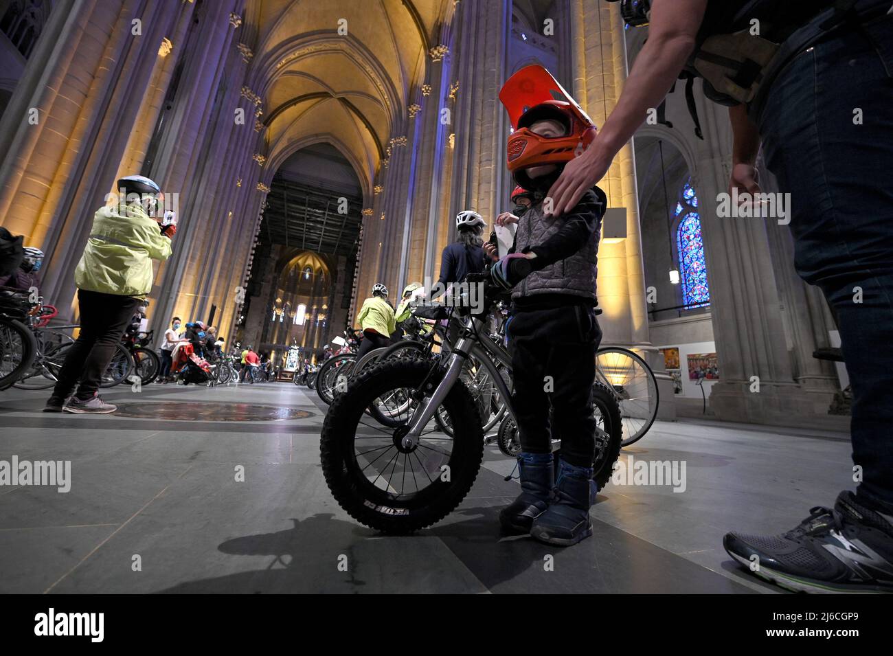 Three year-old Teddy wears his orange helmet as he attends the 24th annual blessing of the bicycles inside The Cathedral of St. John The Divine in New York, NY, April 30, 2022. The annual blessing is ahead of New York City’s 5 Borough bike tour that takes place on Sunday May 1. (Photo by Anthony Behar/Sipa USA) Stock Photo