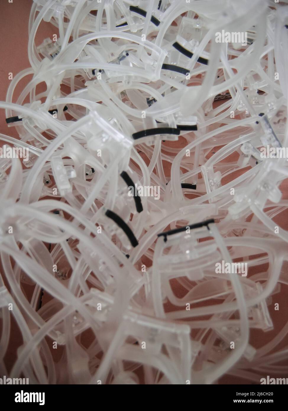 Semi-processed plastic propionate sunglasses lying in a box awaiting the following processing. These are very curved transparent frames that are ready Stock Photo