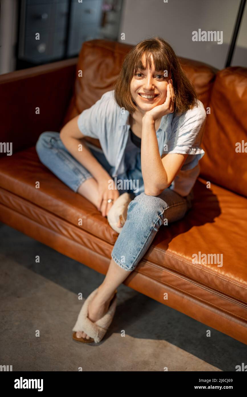 Woman portrait on a couch at home Stock Photo - Alamy