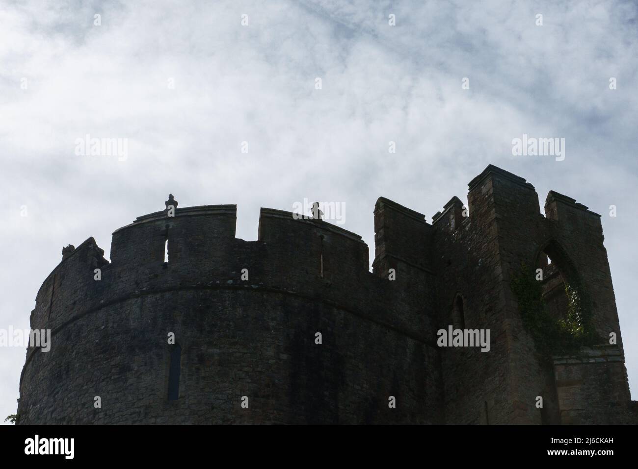 An dark outline of Marten's Tower, Chepstow Castle against a darkening cloudy sky Stock Photo