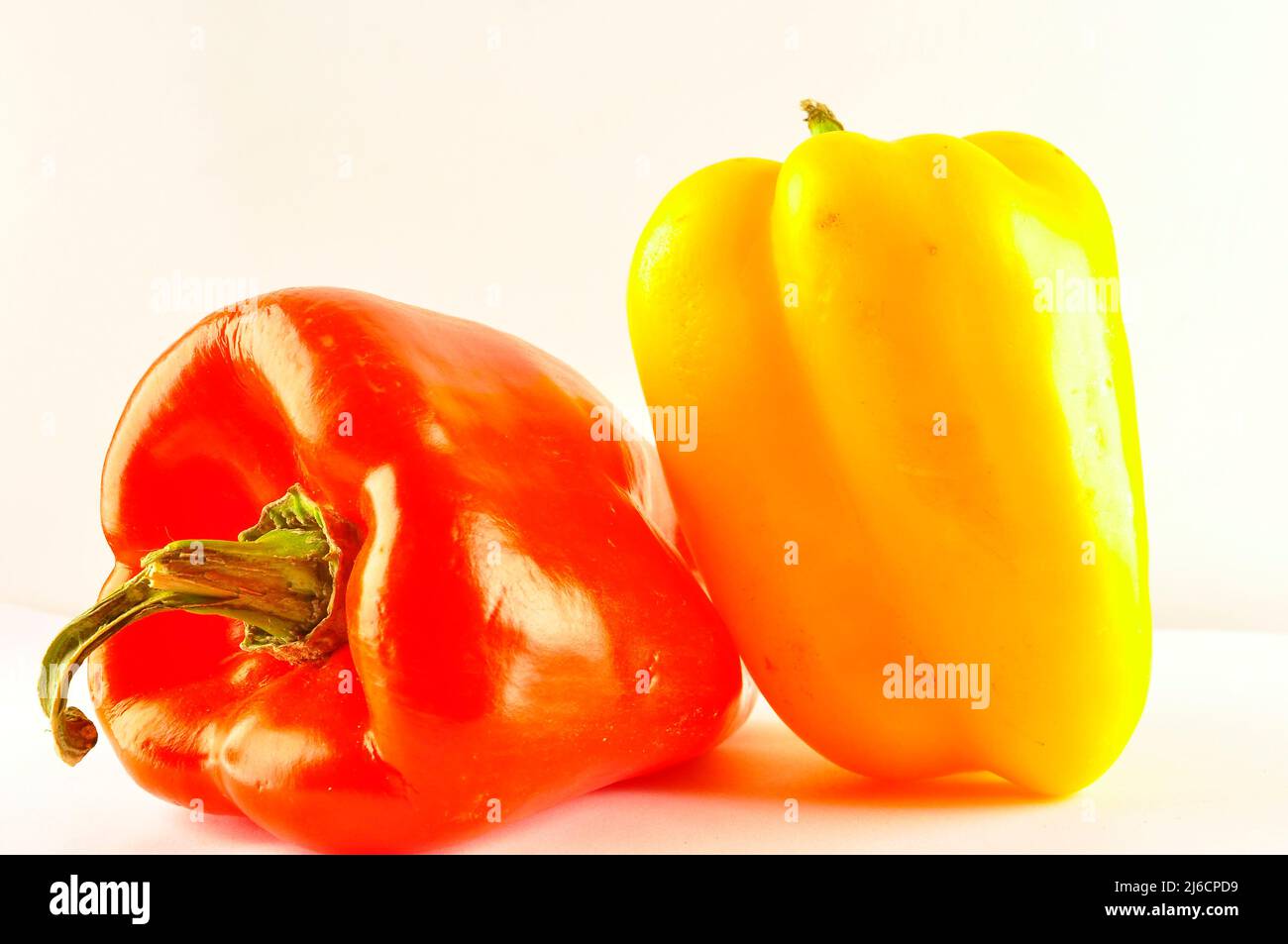 Red and yellow pepper on white background Stock Photo - Alamy