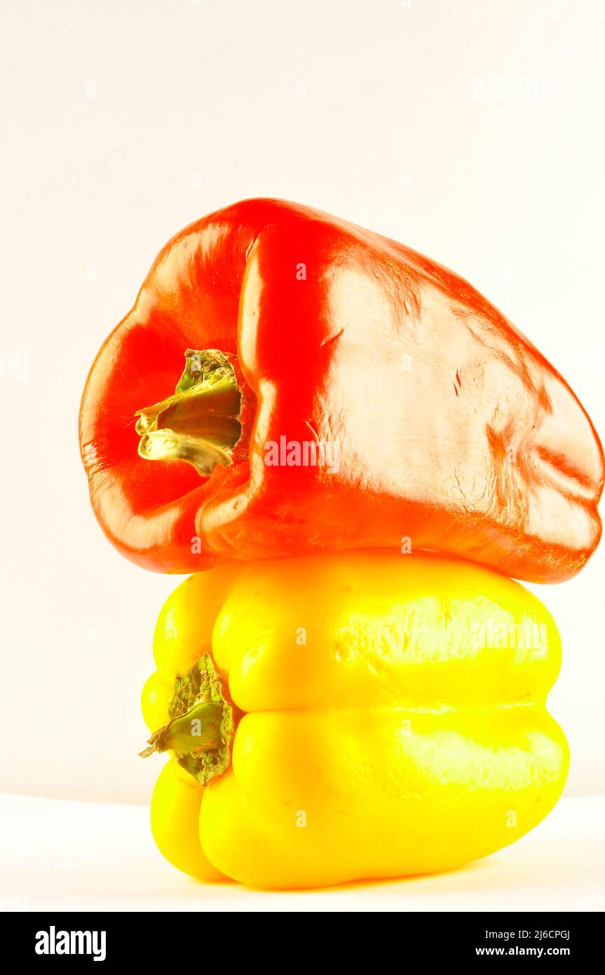 Red and yellow pepper on white background Stock Photo - Alamy