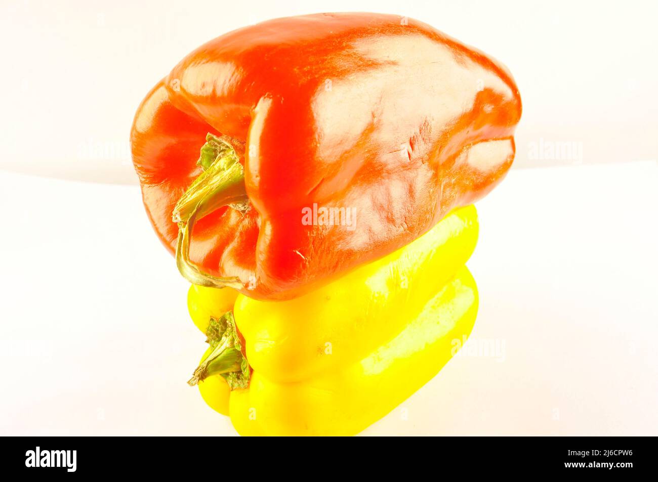 Red and yellow pepper on white background Stock Photo - Alamy