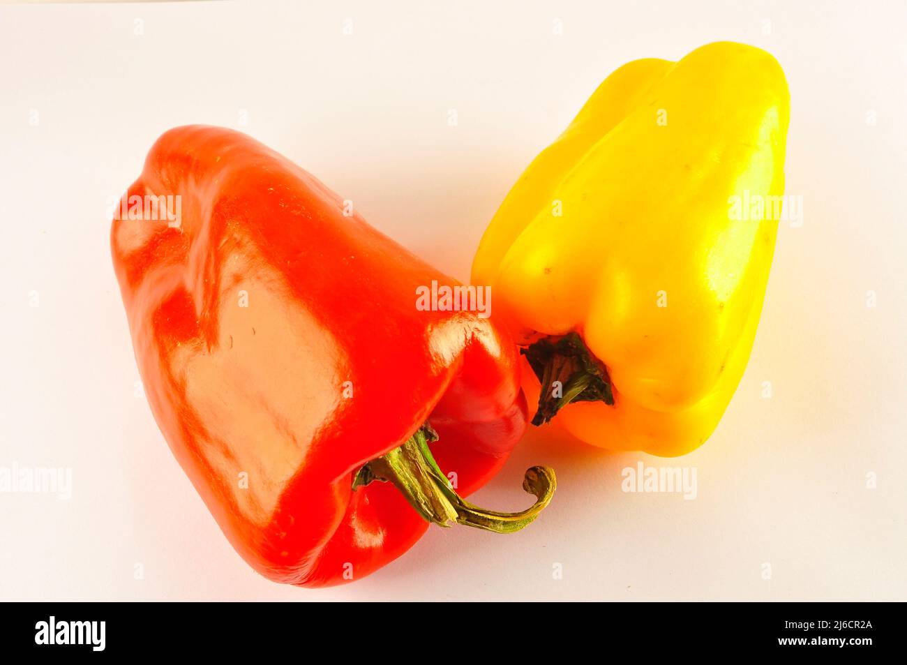 Red and yellow pepper on white background Stock Photo - Alamy