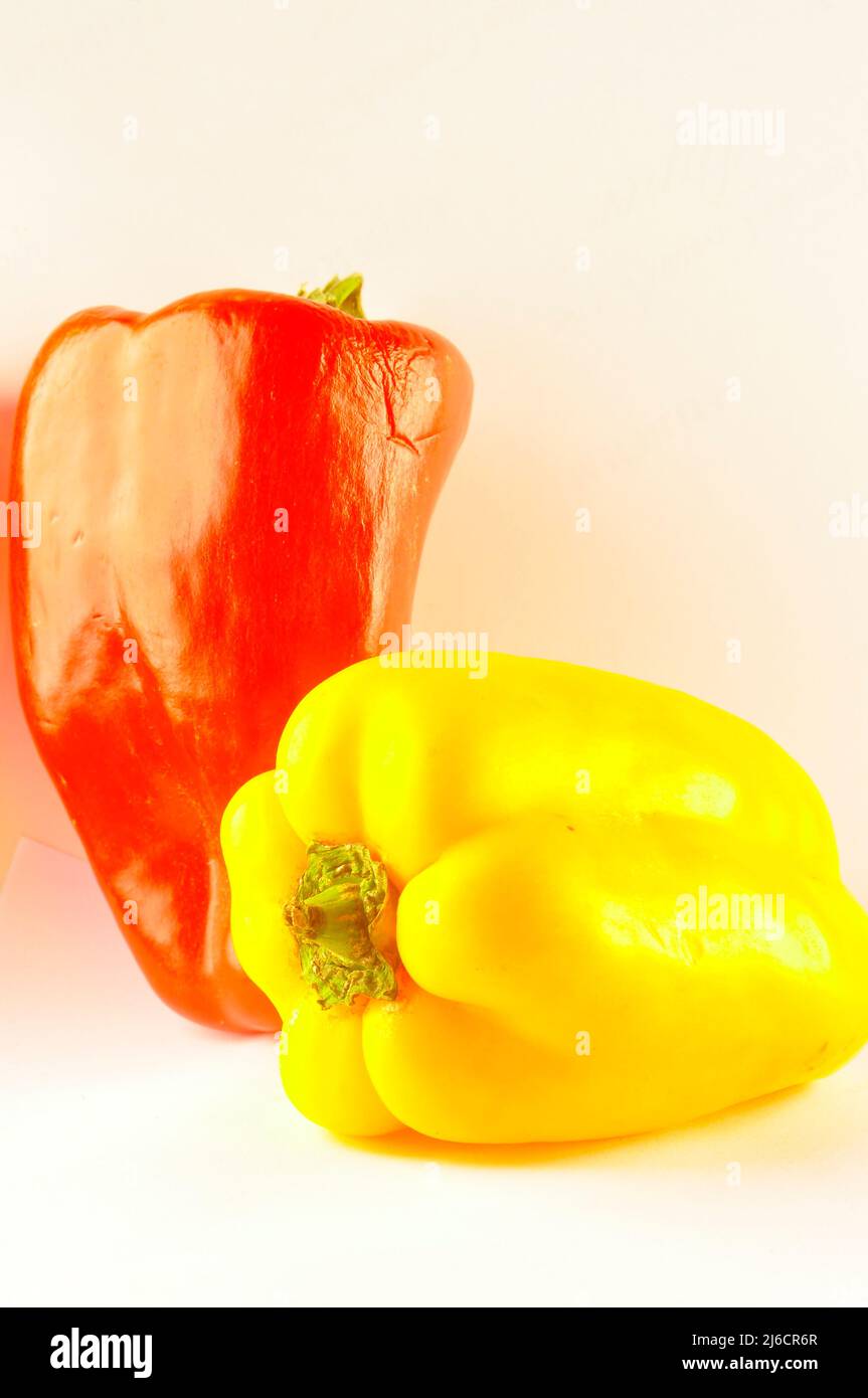 Red and yellow pepper on white background Stock Photo - Alamy