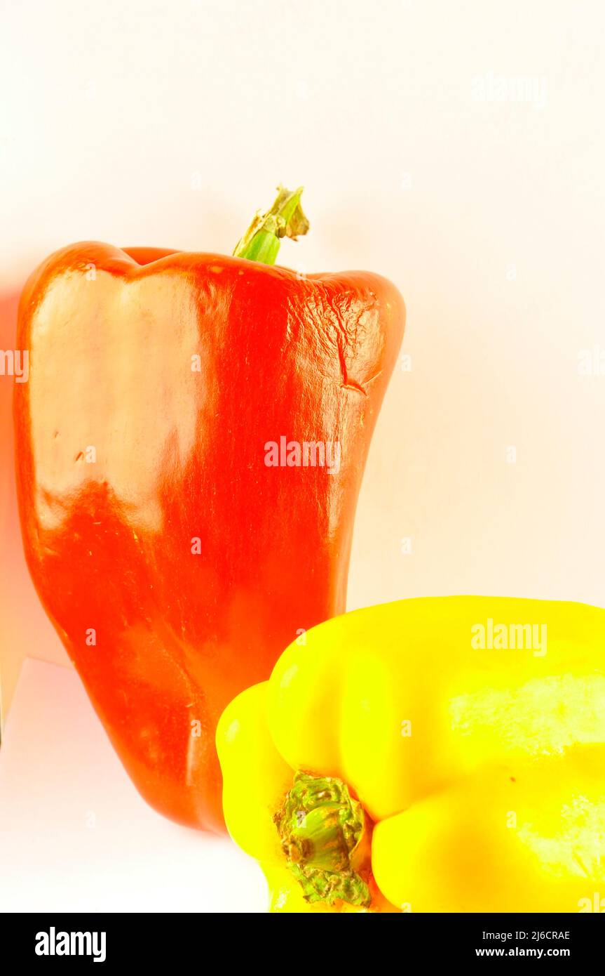 Red and yellow pepper on white background Stock Photo - Alamy
