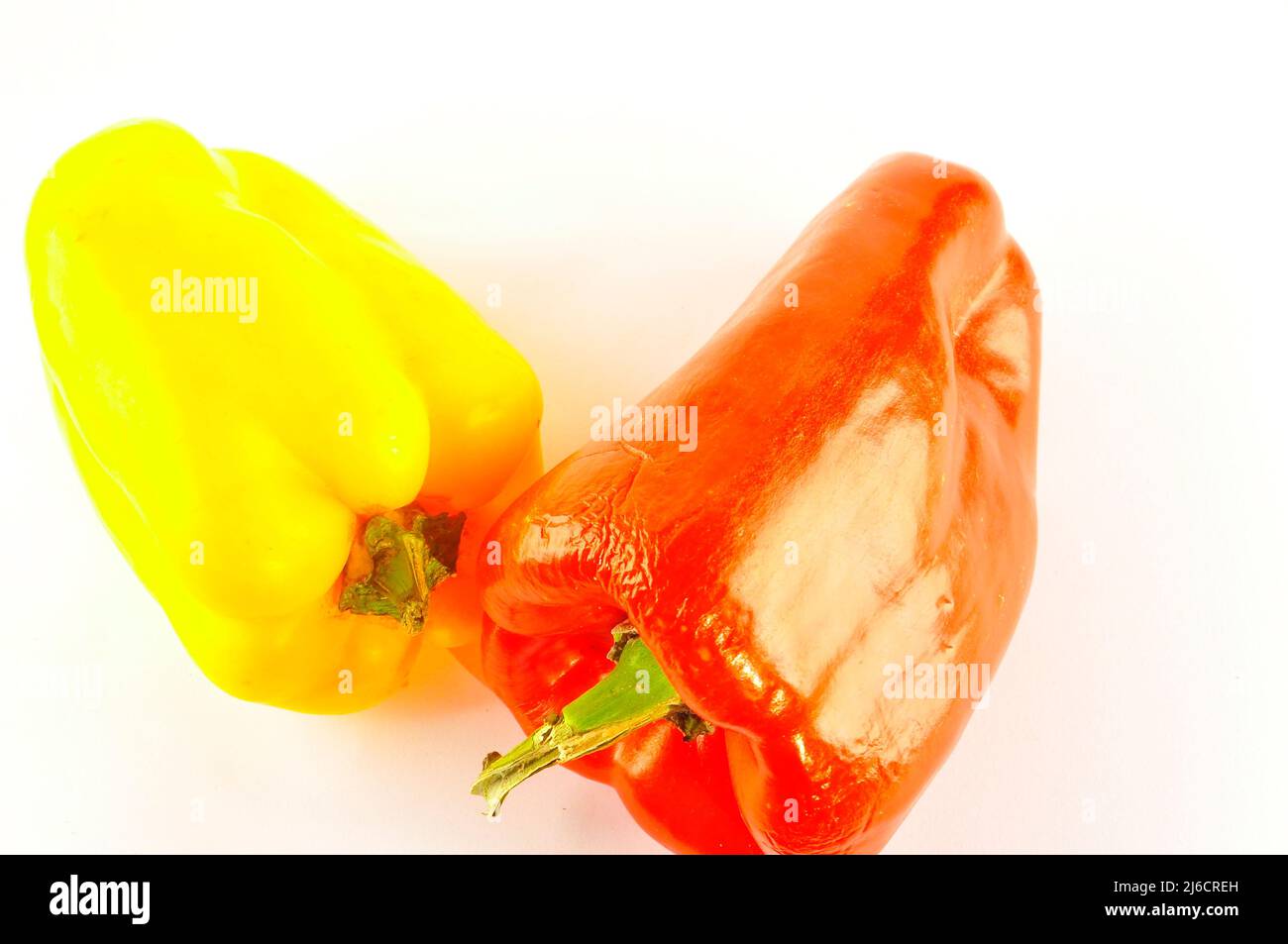 Red and yellow pepper on white background Stock Photo - Alamy