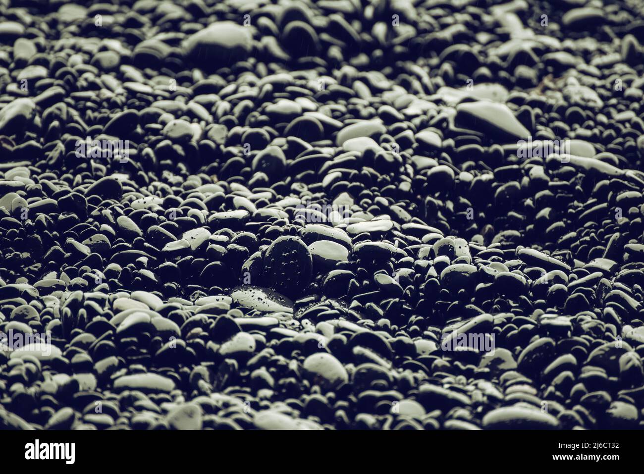 Black pebbles background Stock Photo - Alamy