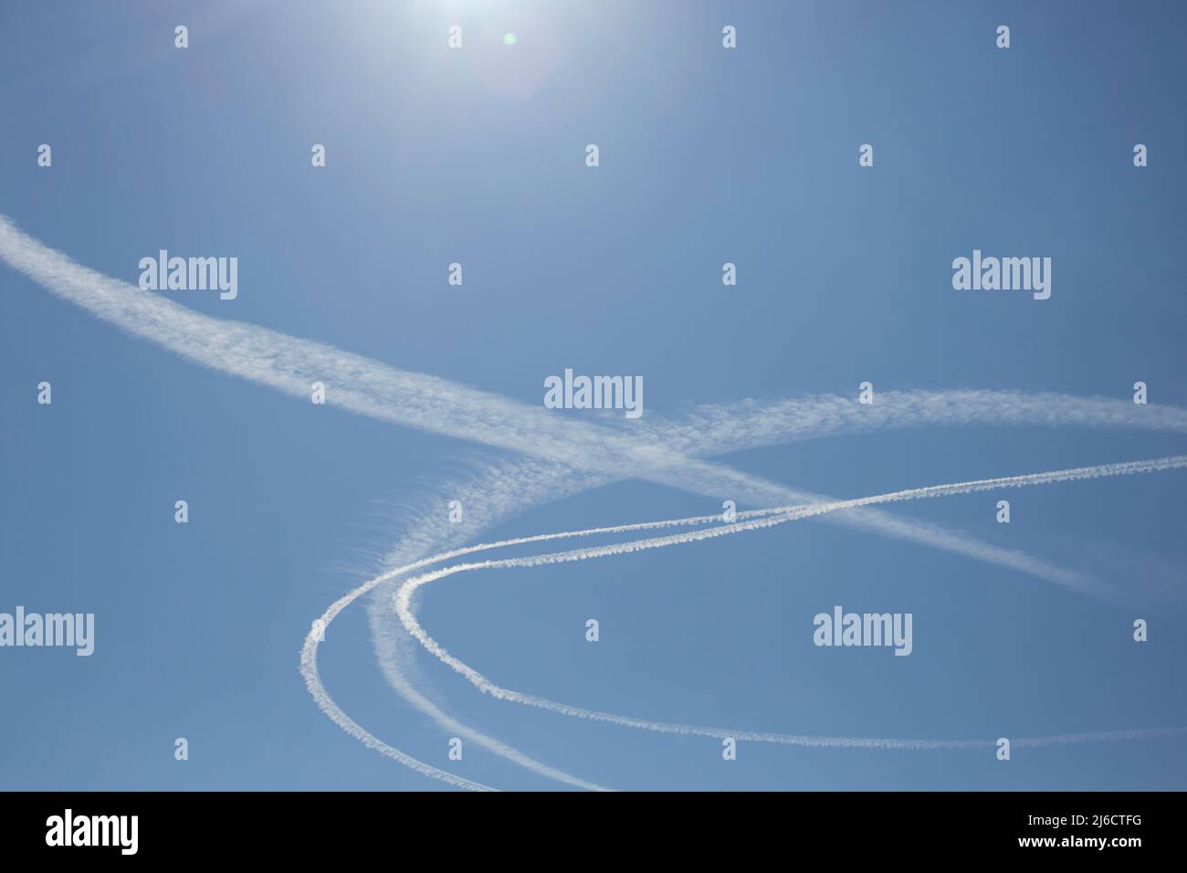 circular condensation trail made from aerial patrol jets Stock Photo