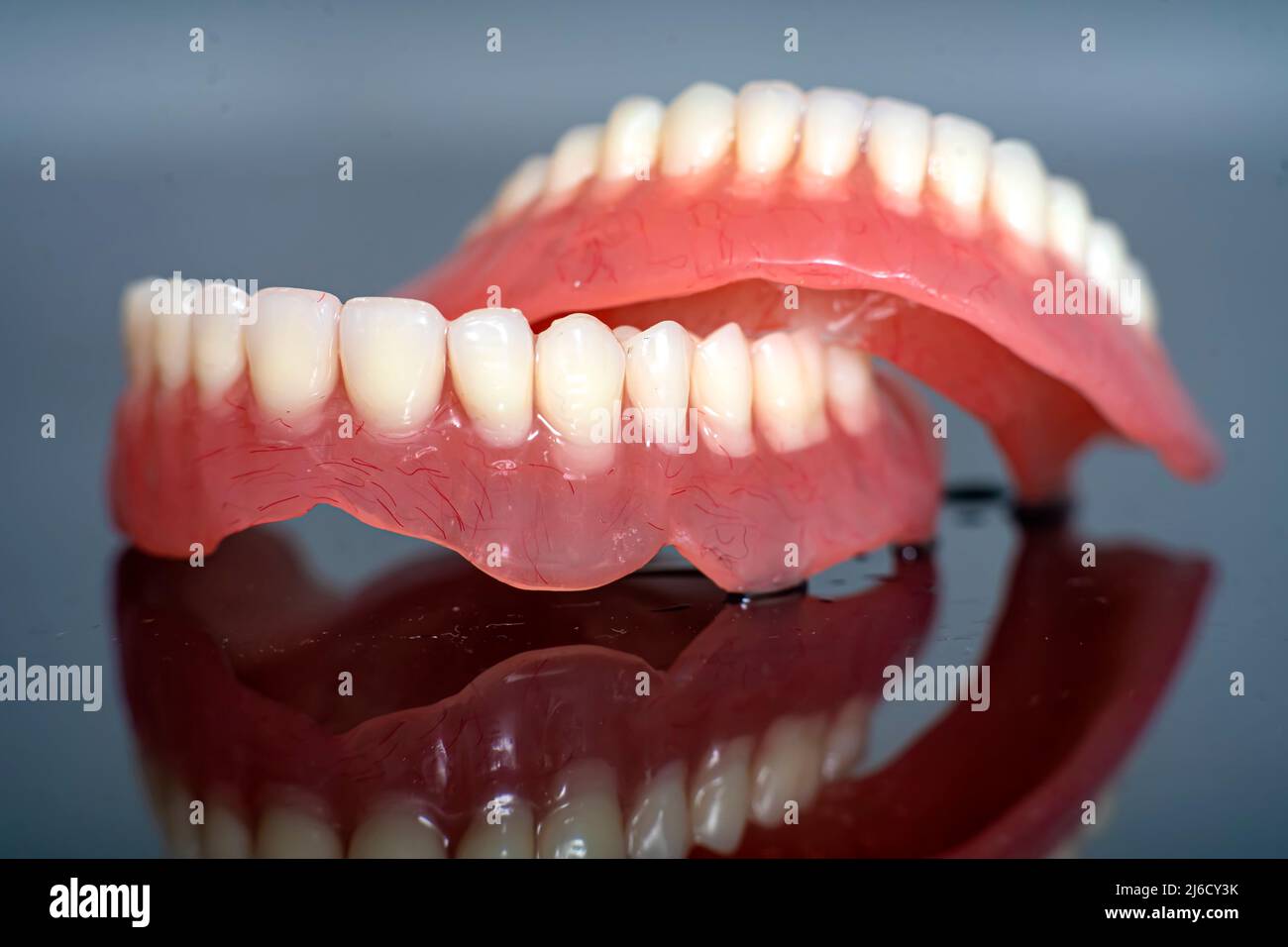model of teeth for dentists to explain various tooth diseases or problems. grey background Stock
