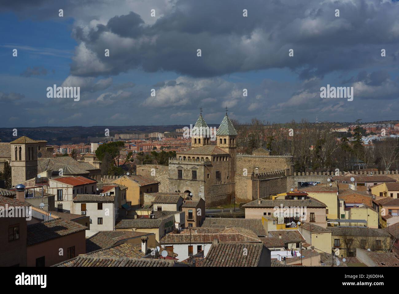 Spain, Toledo. Panoramic view of the city in which it can be seen the New Bisagra Gate (Puerta Nueva de Bisagra) of Moorish origin, rebuilt in the 16th century by Alonso de Covarrubias (1488-1570). On the left, the Church of Santiago el Mayor, built in the 13th century in Mudejar style. Restored in the 20th century. Stock Photo