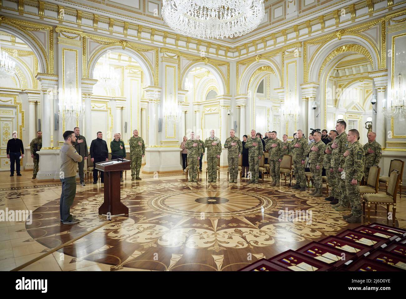 Kyiv, Ukraine. 29 April, 2022. Ukrainian President Volodymyr Zelenskyy, left, stands for the national anthem during a State Awards ceremony presenting medals to members of the Ukrainian Armed Forces at the Mariyinsky palace, April 29, 2022 in Kyiv, Ukraine.  Credit: Ukraine Presidency/Ukraine Presidency/Alamy Live News Stock Photo