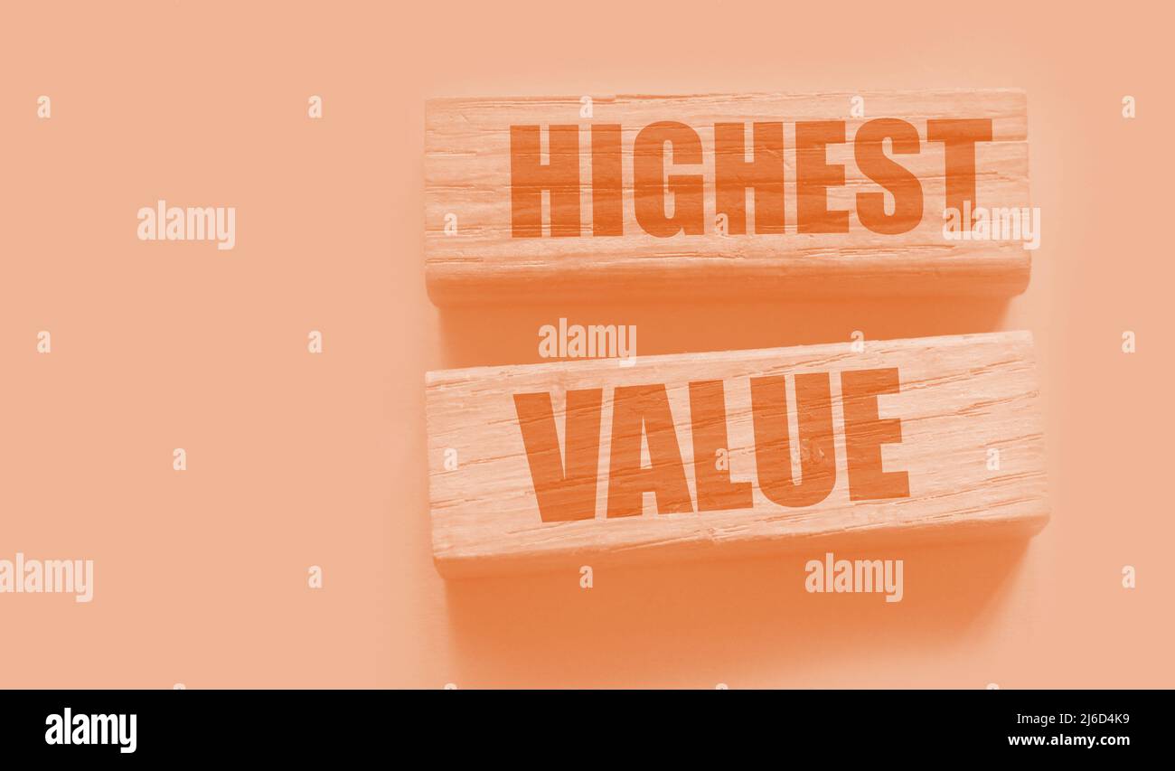 Highest values words on wooden building blocks isolated on yellow. Social, business and education concept. Stock Photo