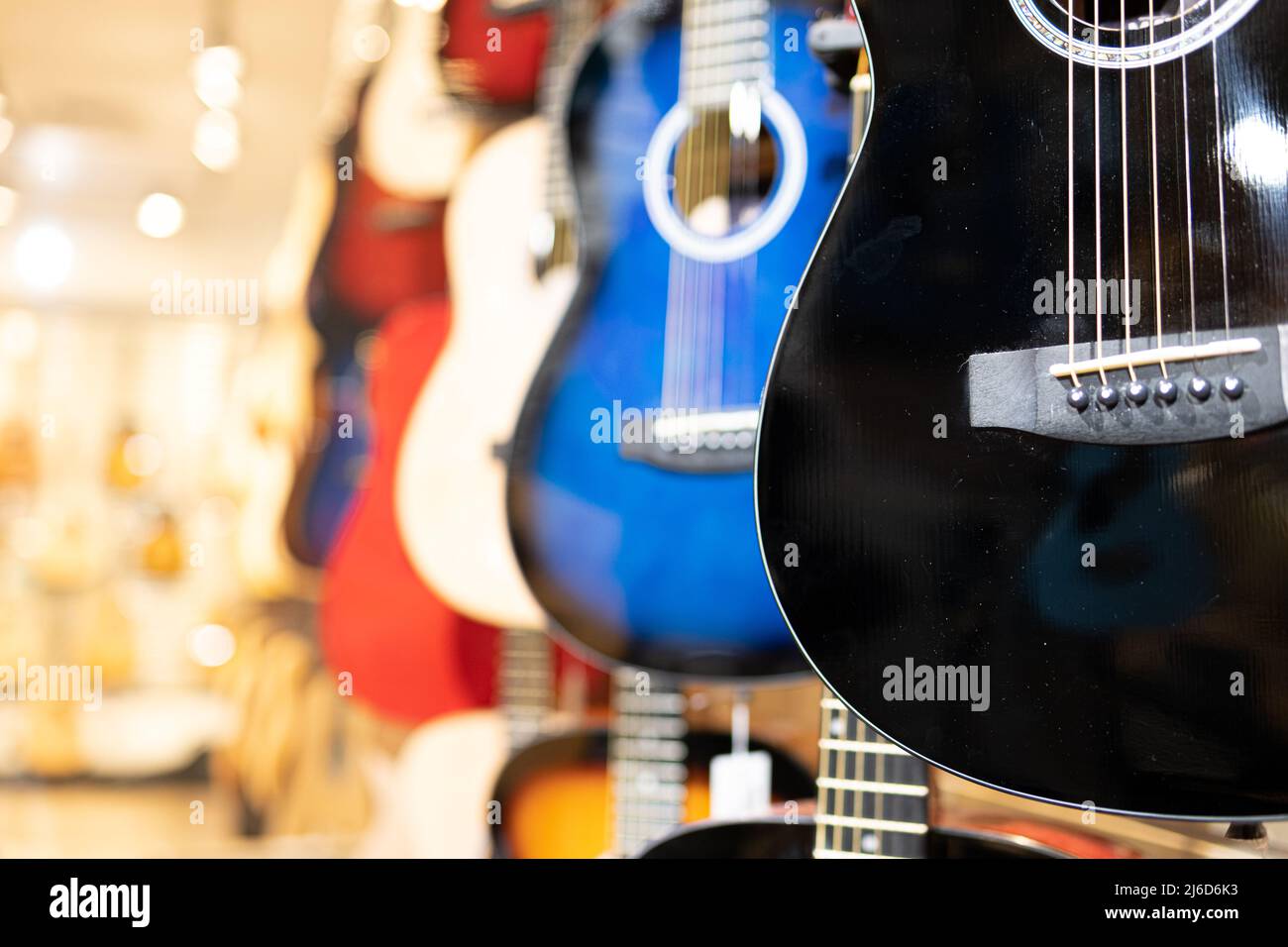 Guitars on display in music instruments store in a mall Stock Photo Alamy