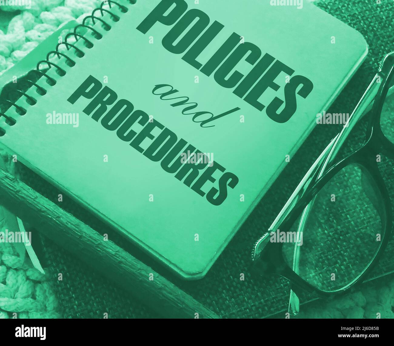 Procedure Notebook Policies and Procedures text on notebook ,pencil and glasses. Law ...