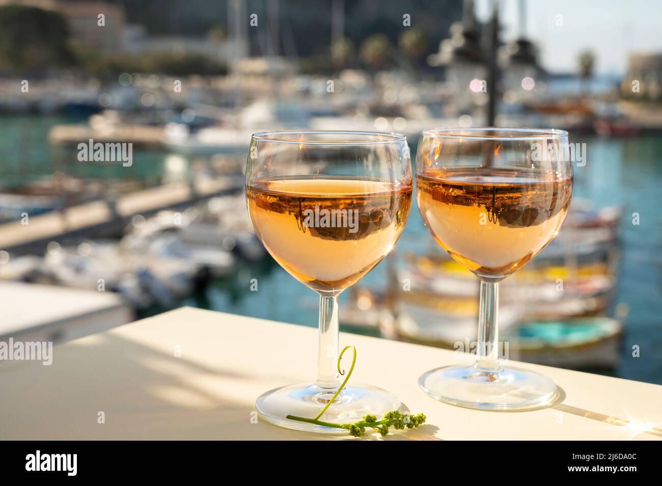 Summer party with cold rose Provencal wine in glass served in sunlights