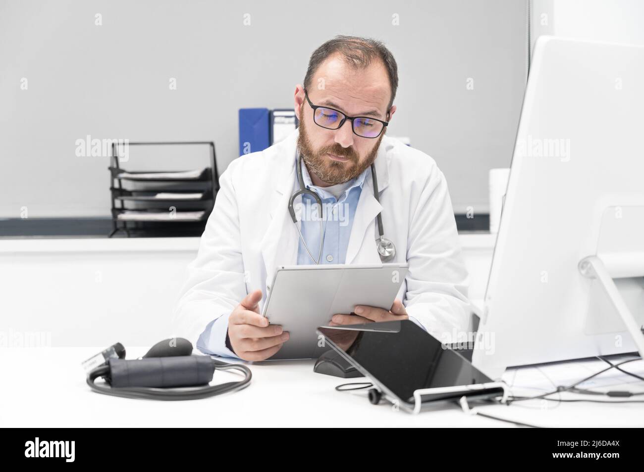Doctor using his tablet computer at work. High quality photo Stock Photo