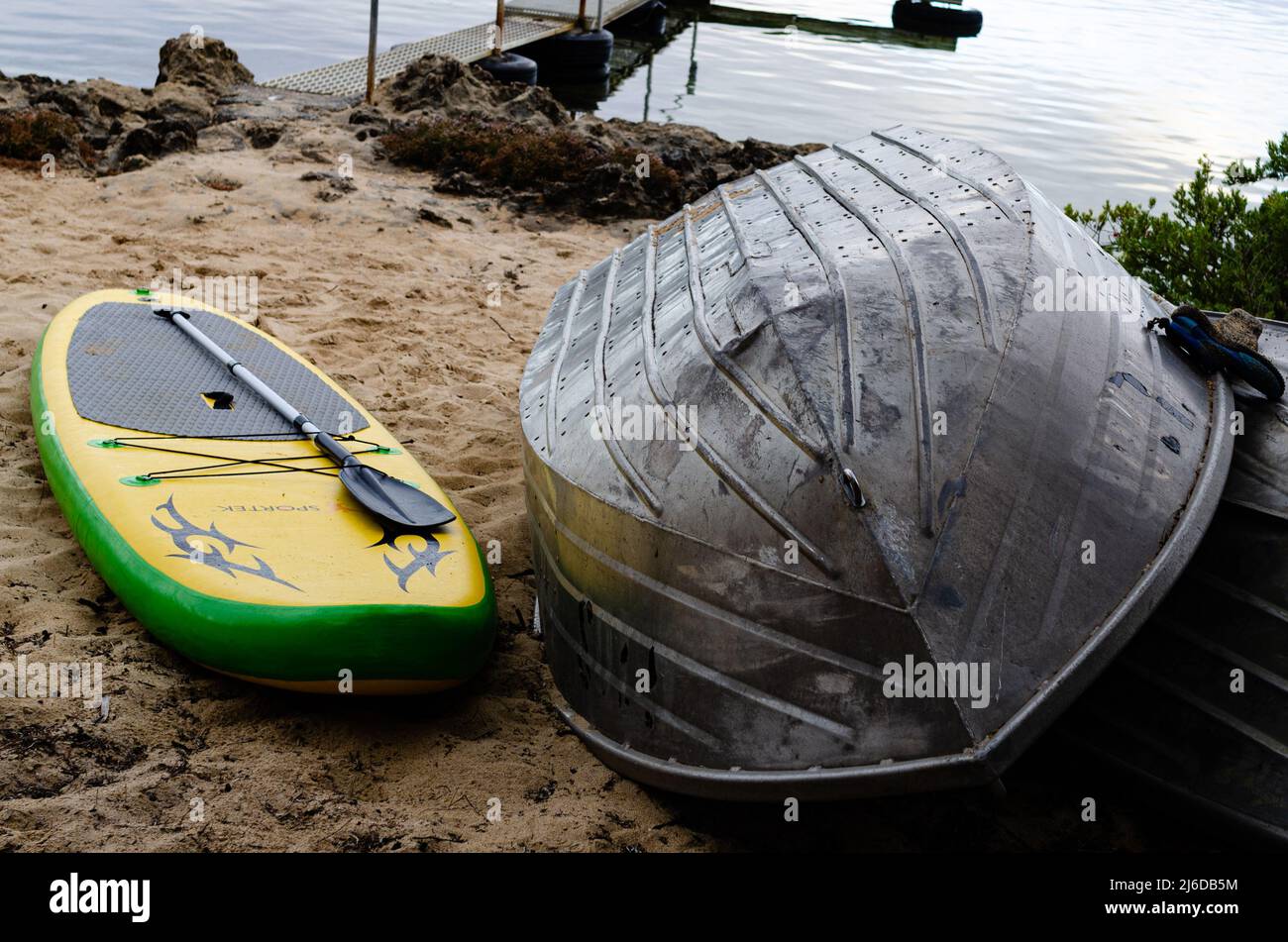 board and boat on beach Stock Photo Alamy
