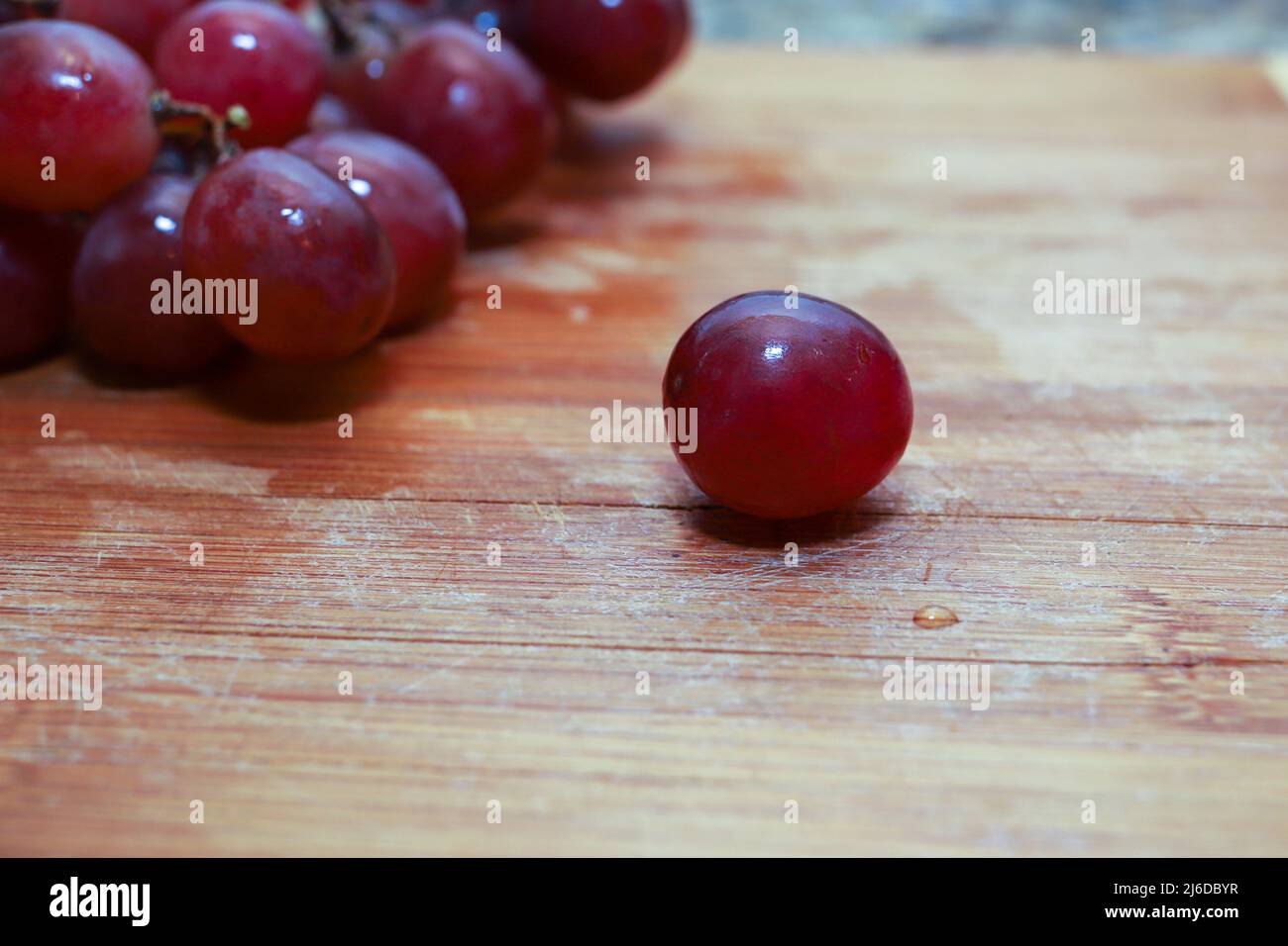 A close-up of a fresh organic red grape on a table Stock Photo