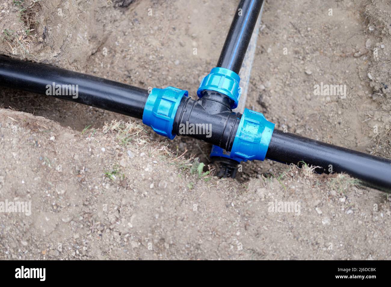 Installed PVC water pipes are assembled and laid in trench at