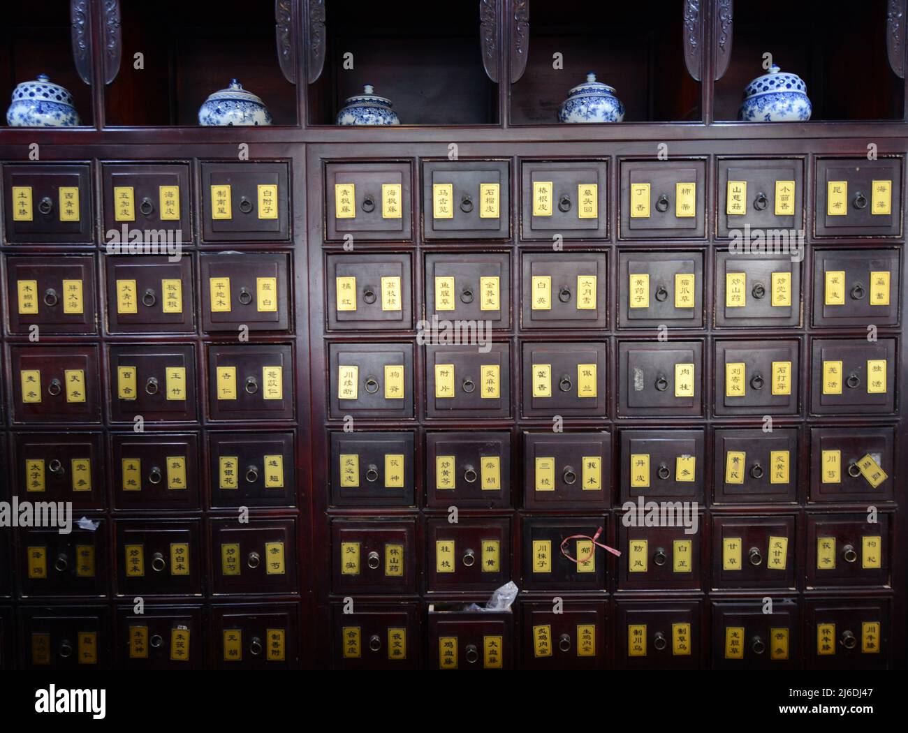 A traditional Chinese medicine with many drawers holding herbs