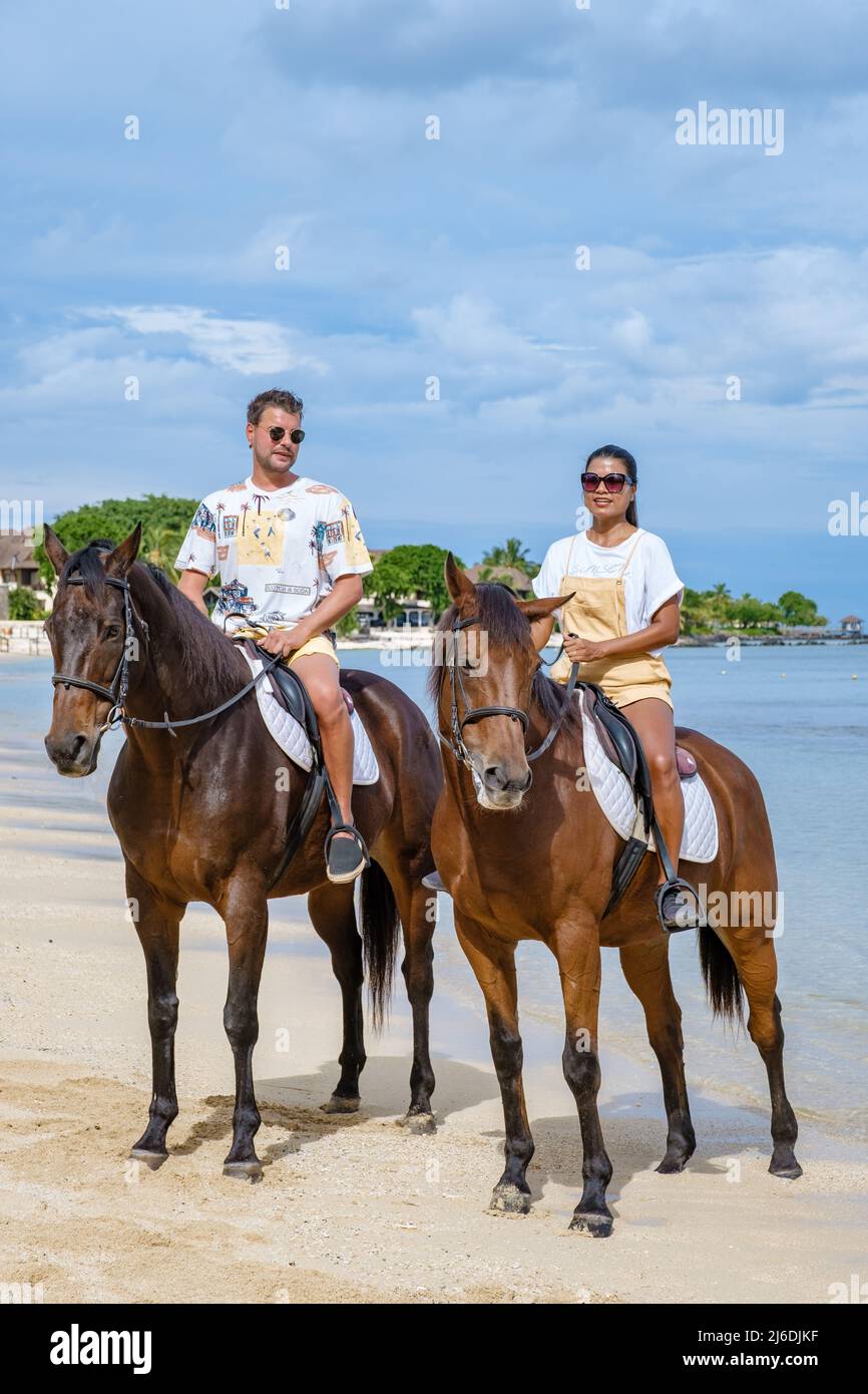 horse riding on the beach, man and woman on a horse on the beach during a luxury vacation in